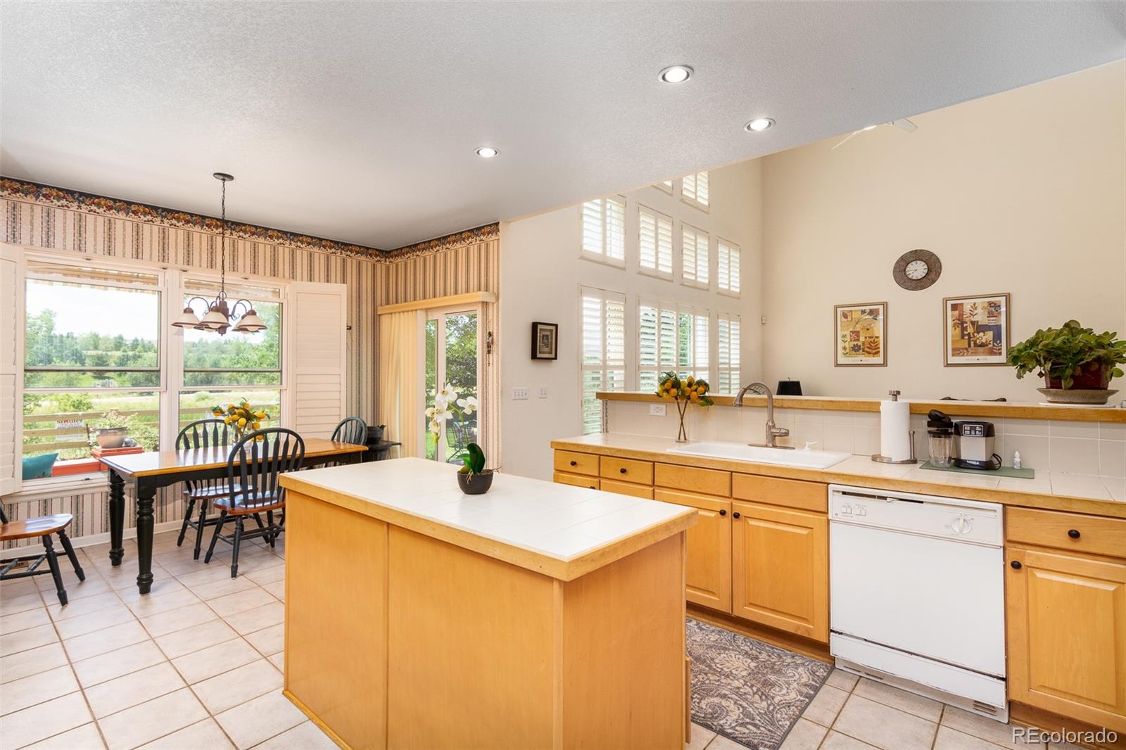 1082 Eldorado Drive Superior, CO 80027 - Photo 9 of 40 a kitchen with a sink and chairs