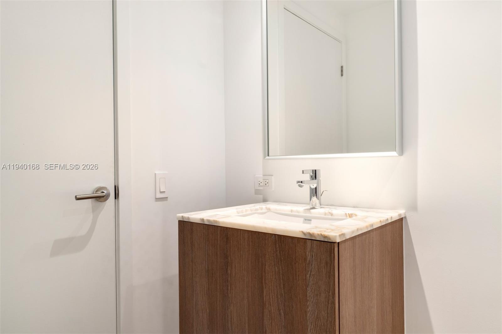 500 Alton Road, Unit 2207 Miami Beach, FL 33139 - Photo 12 of 16 a bathroom with a sink and a mirror