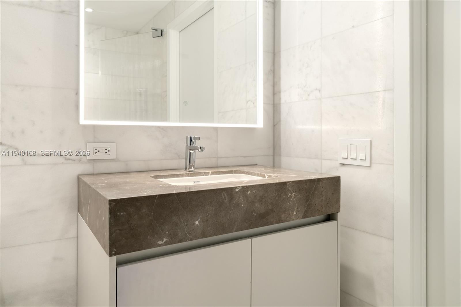 500 Alton Road, Unit 2207 Miami Beach, FL 33139 - Photo 6 of 16 a sink with a cabinet and mirror