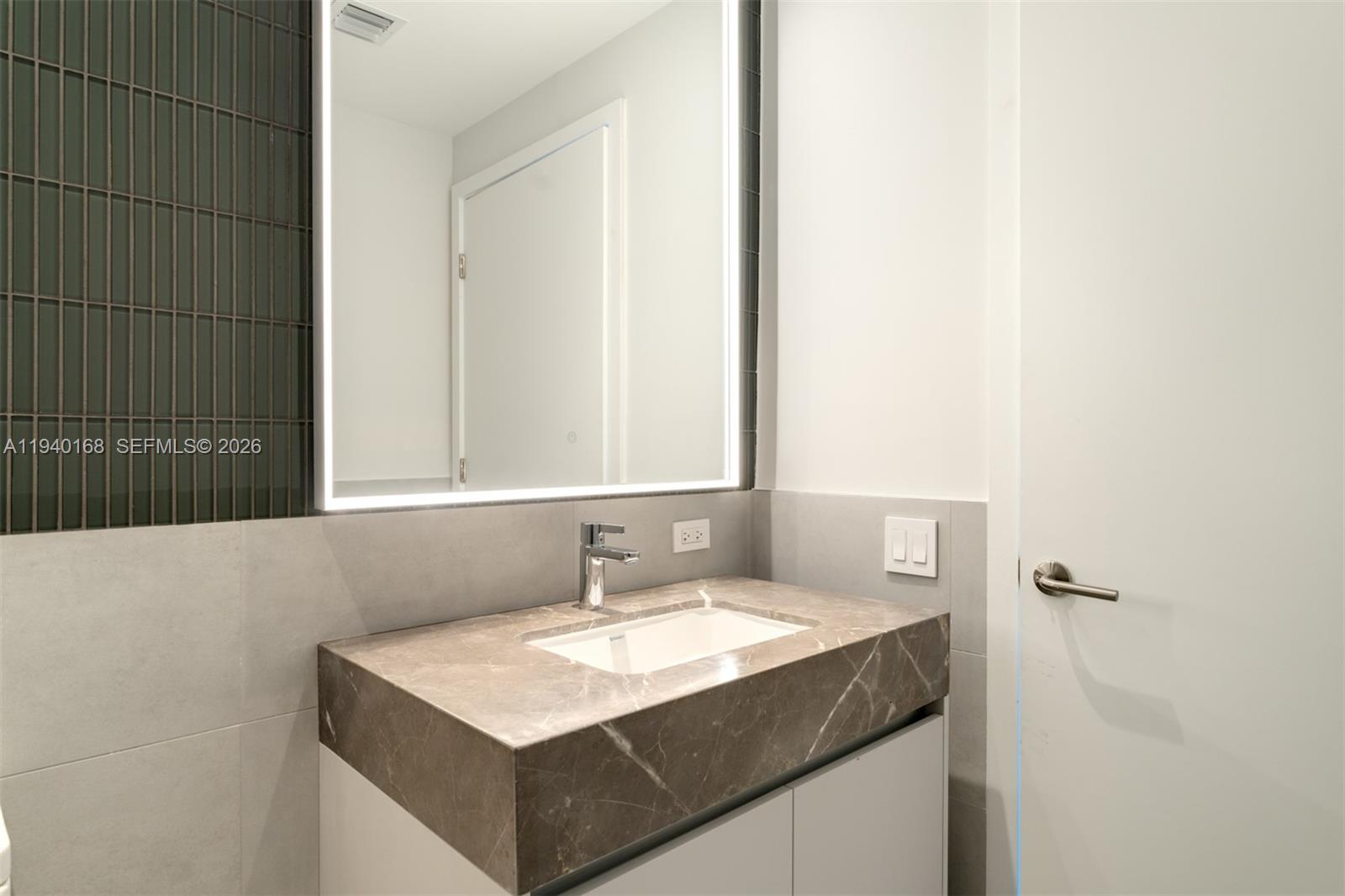 500 Alton Road, Unit 2207 Miami Beach, FL 33139 - Photo 10 of 16 a bathroom with a sink and a mirror