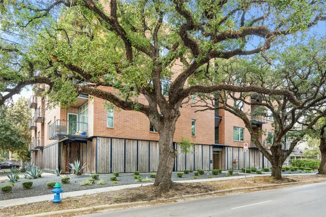 a front view of a building with trees