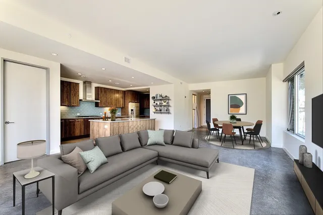 a living room with furniture white walls and kitchen view