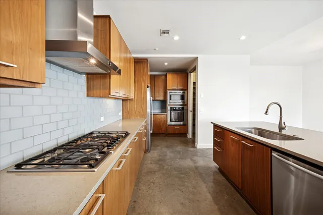 a kitchen with sink a stove and refrigerator