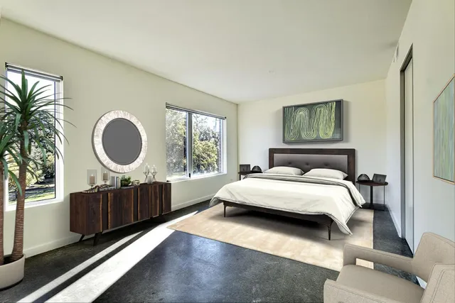 a bedroom with a large bed and a large window