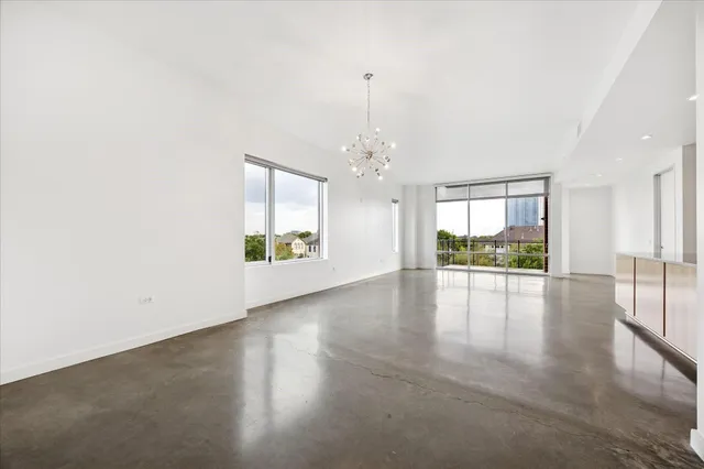 a large kitchen with stainless steel appliances granite countertop a sink and a refrigerator