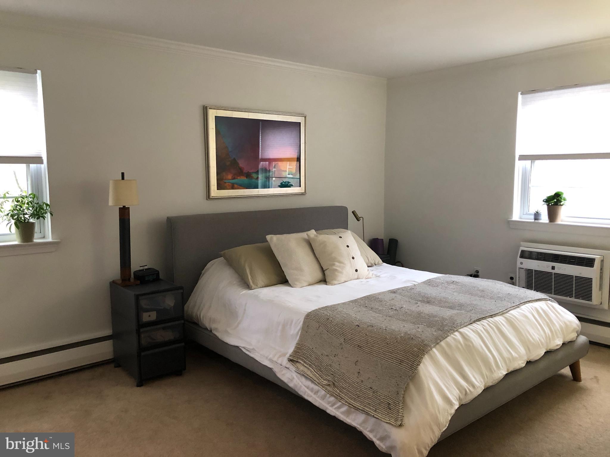 61 Llanfair Road, Unit A1 Ardmore, PA 19003 - Photo 7 of 9 a bedroom with a bed and a window