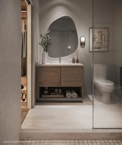 a bathroom with a toilet and a mirror