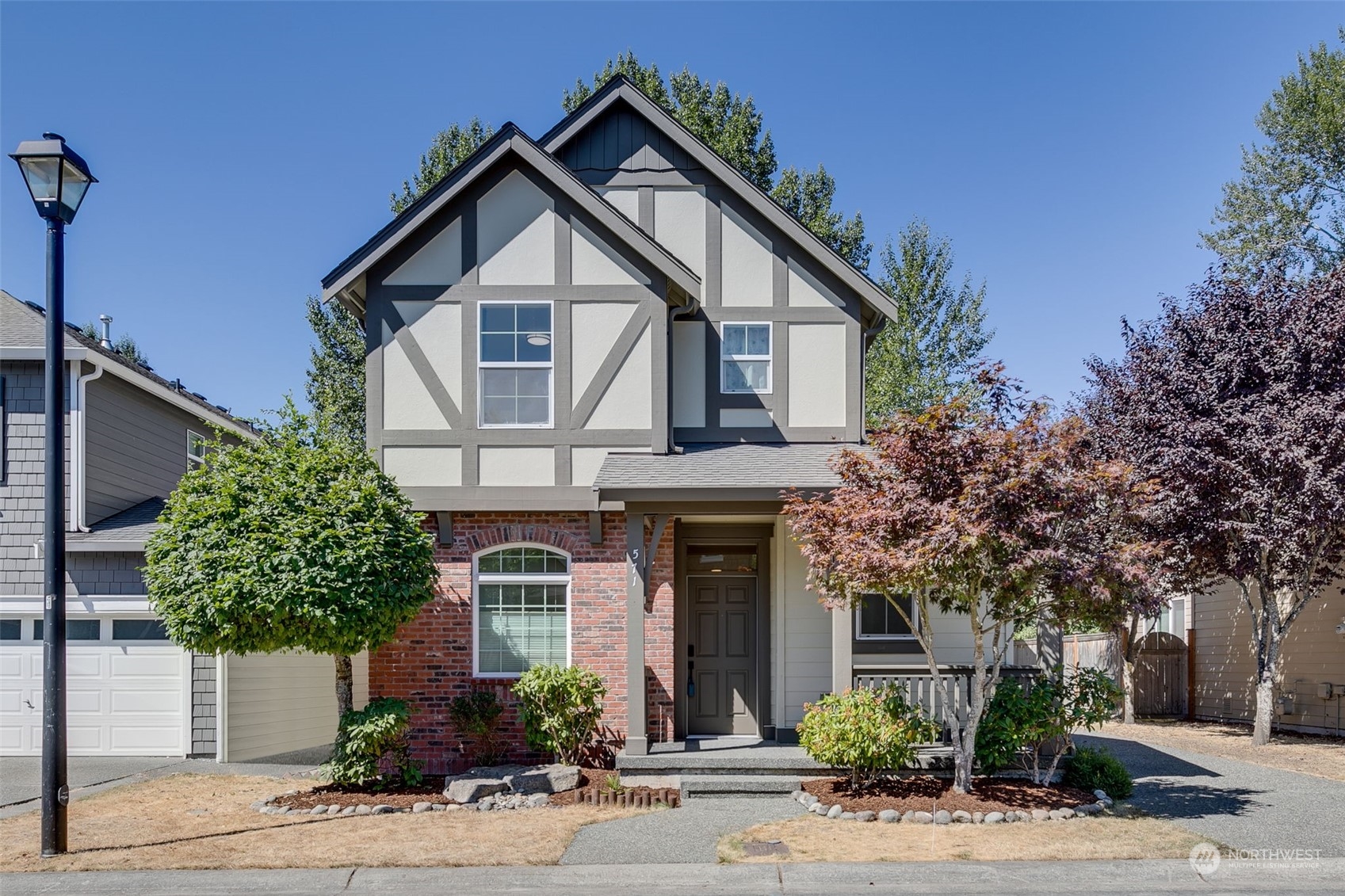 571 Lyons Place Northeast Renton, WA 98059 - Photo 1 of 27 a front view of a house with a yard