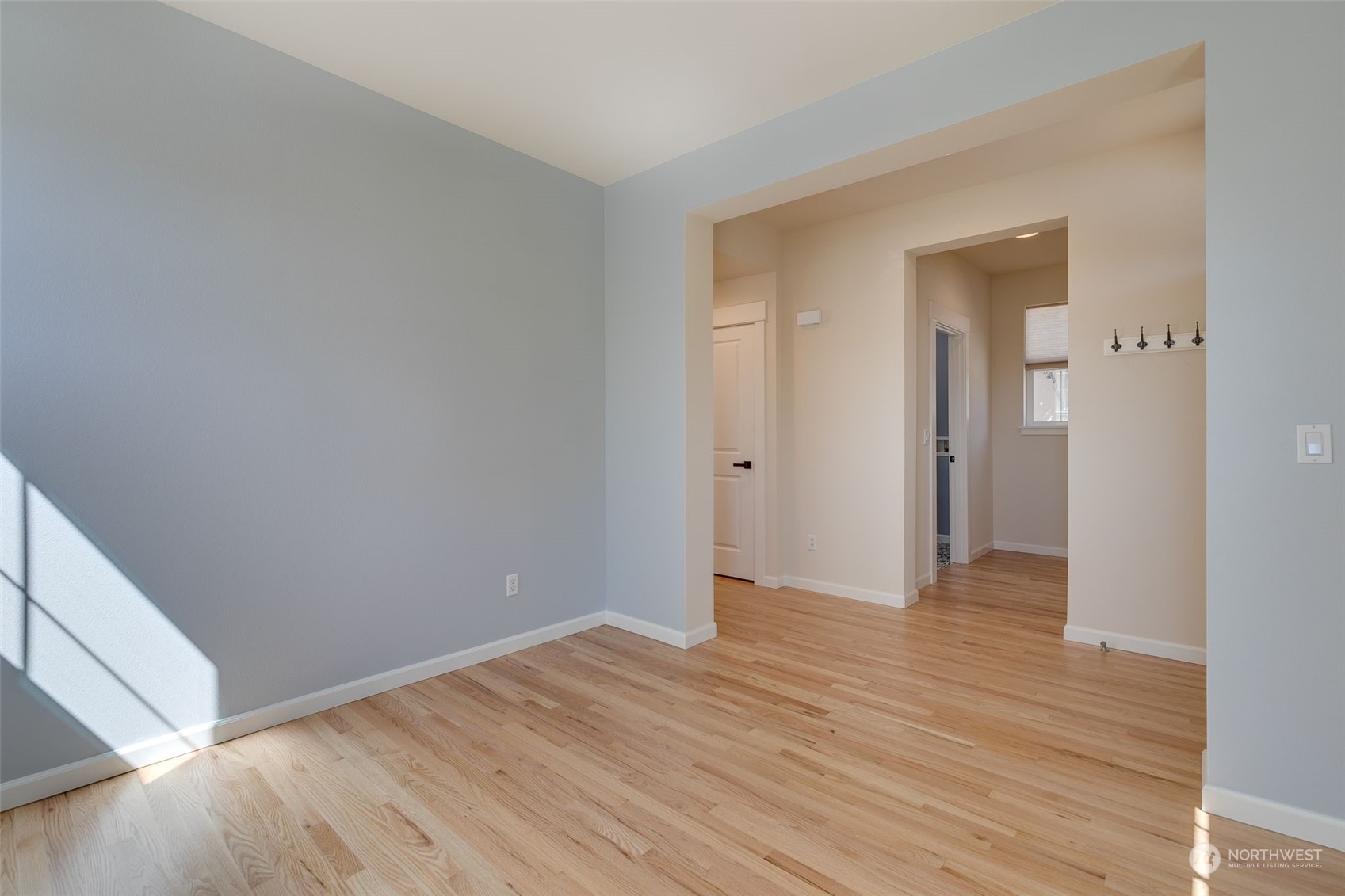 571 Lyons Place Northeast Renton, WA 98059 - Photo 14 of 27 a view of an empty room with wooden floor