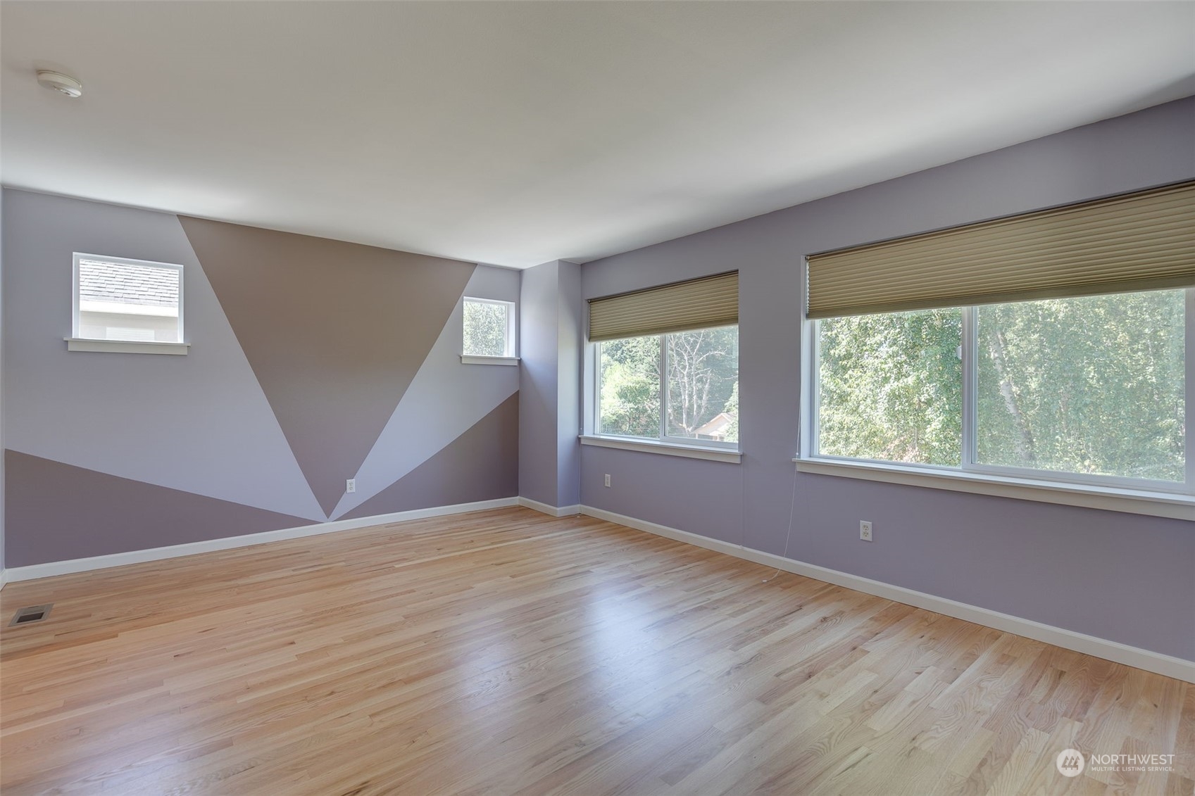 571 Lyons Place Northeast Renton, WA 98059 - Photo 15 of 27 an empty room with wooden floor and windows