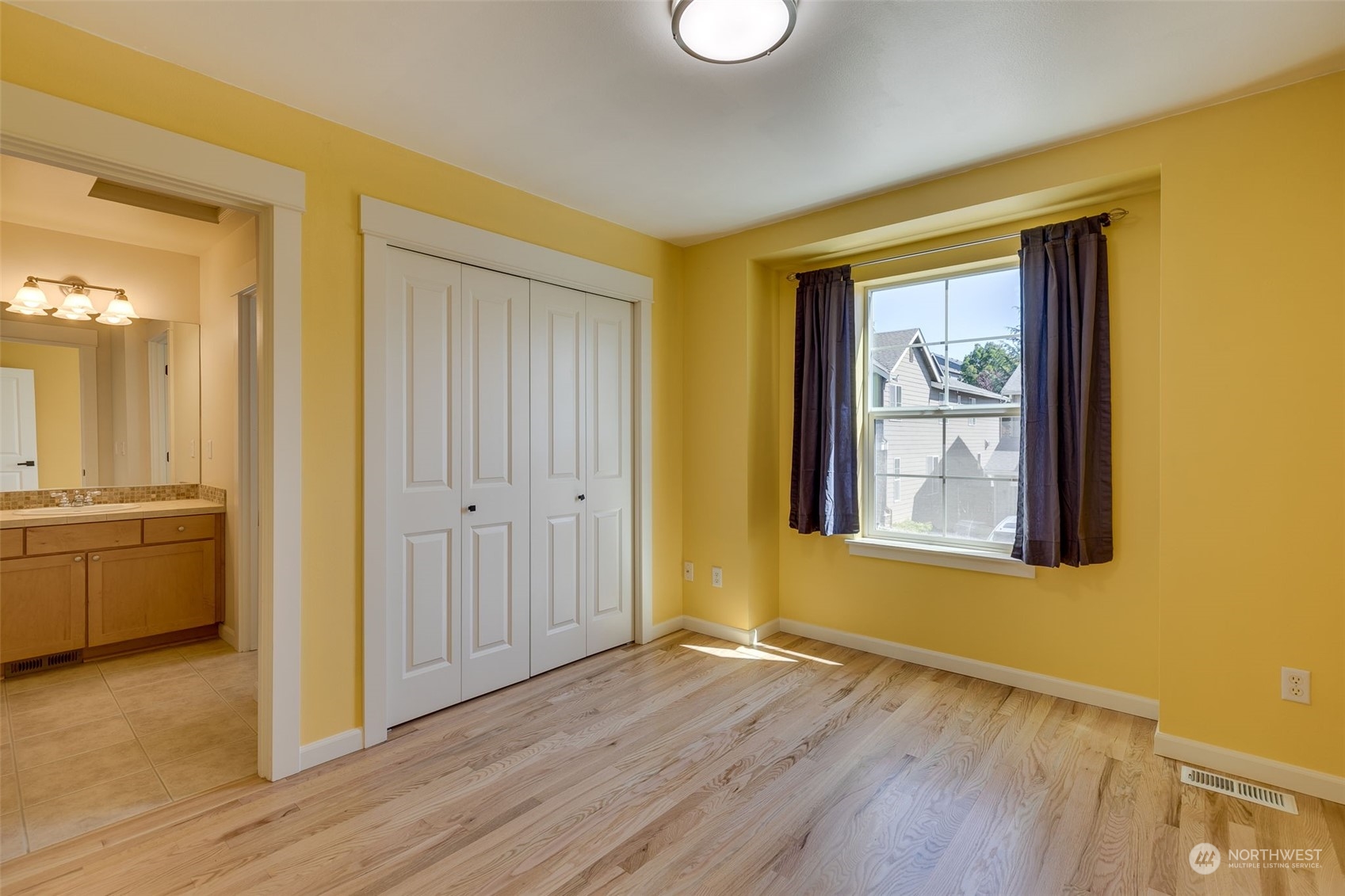 571 Lyons Place Northeast Renton, WA 98059 - Photo 20 of 27 a view of an empty room with window and wooden floor