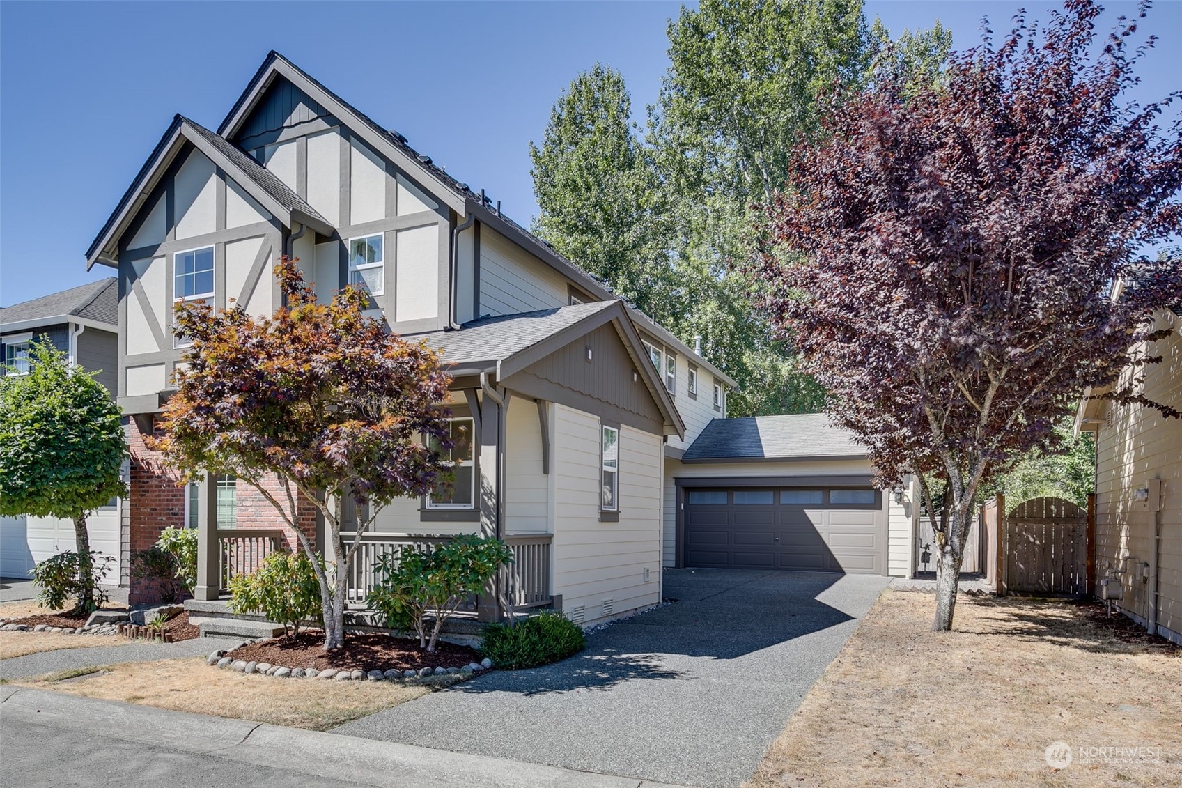 571 Lyons Place Northeast Renton, WA 98059 - Photo 2 of 27 a front view of a house with a yard and garage
