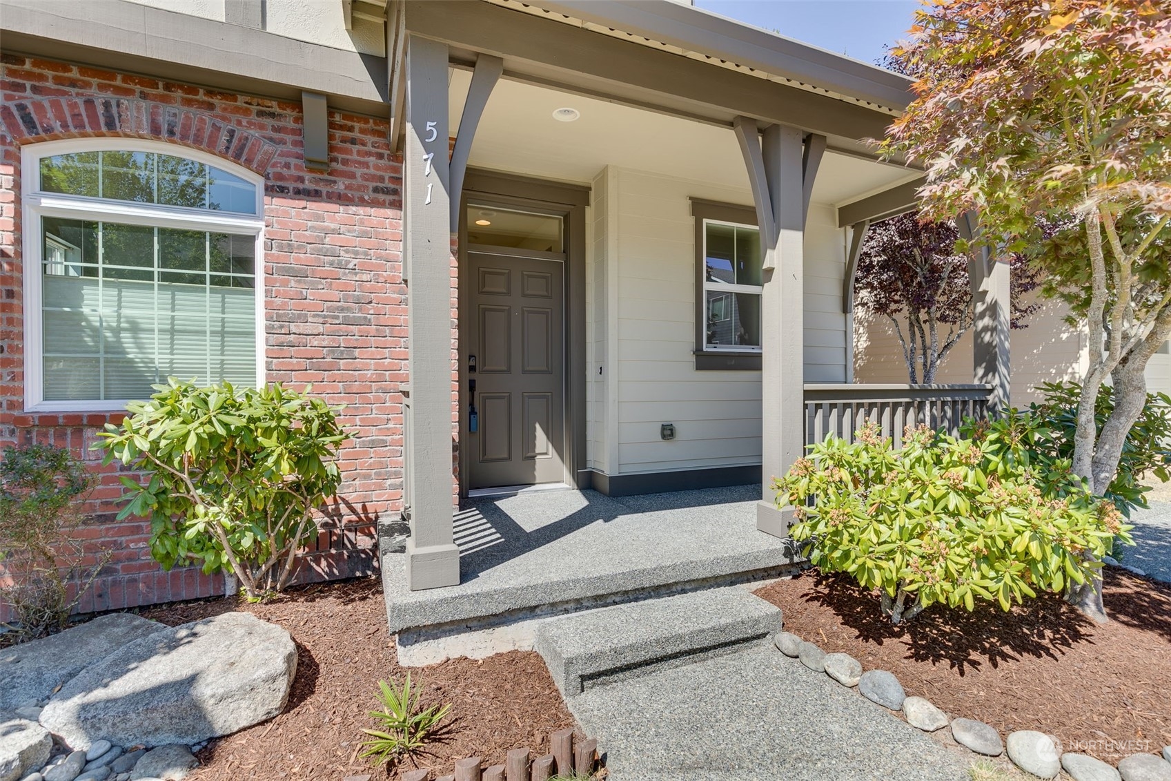571 Lyons Place Northeast Renton, WA 98059 - Photo 3 of 27 a house with potted plants in front of door