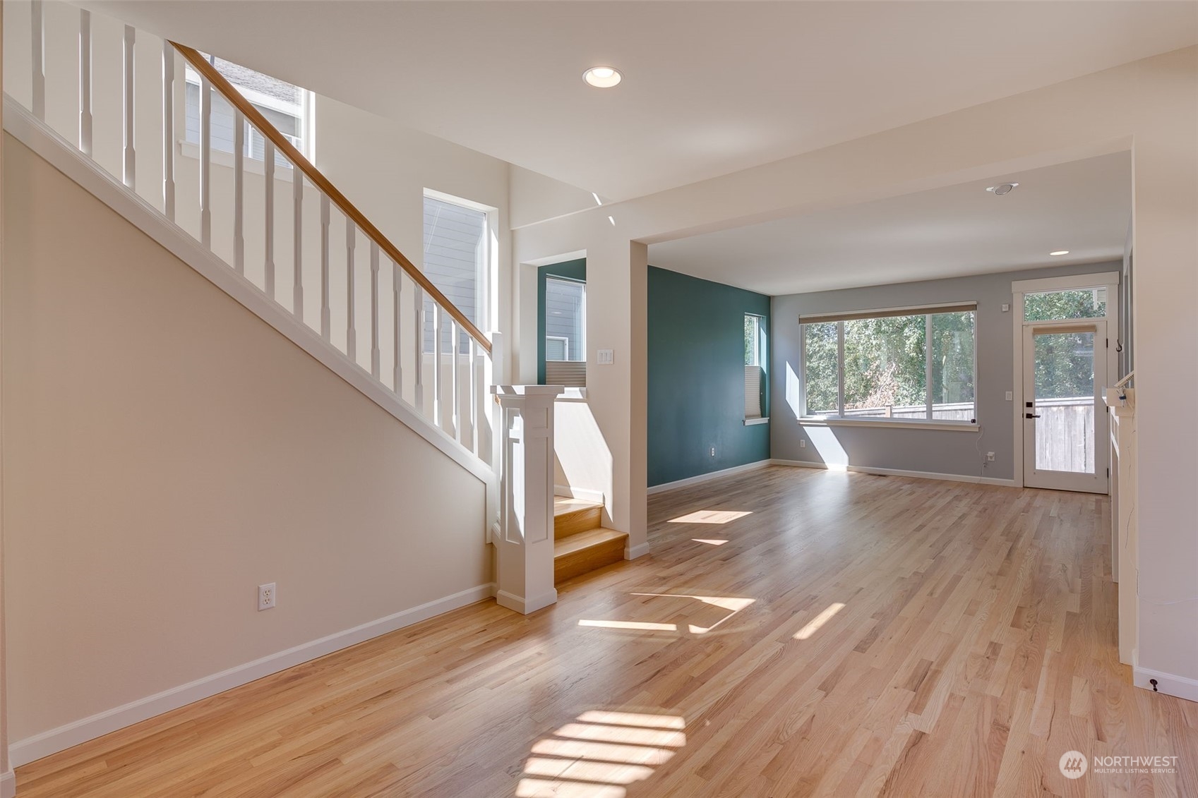 571 Lyons Place Northeast Renton, WA 98059 - Photo 8 of 27 a view of an empty room with wooden floor and a window