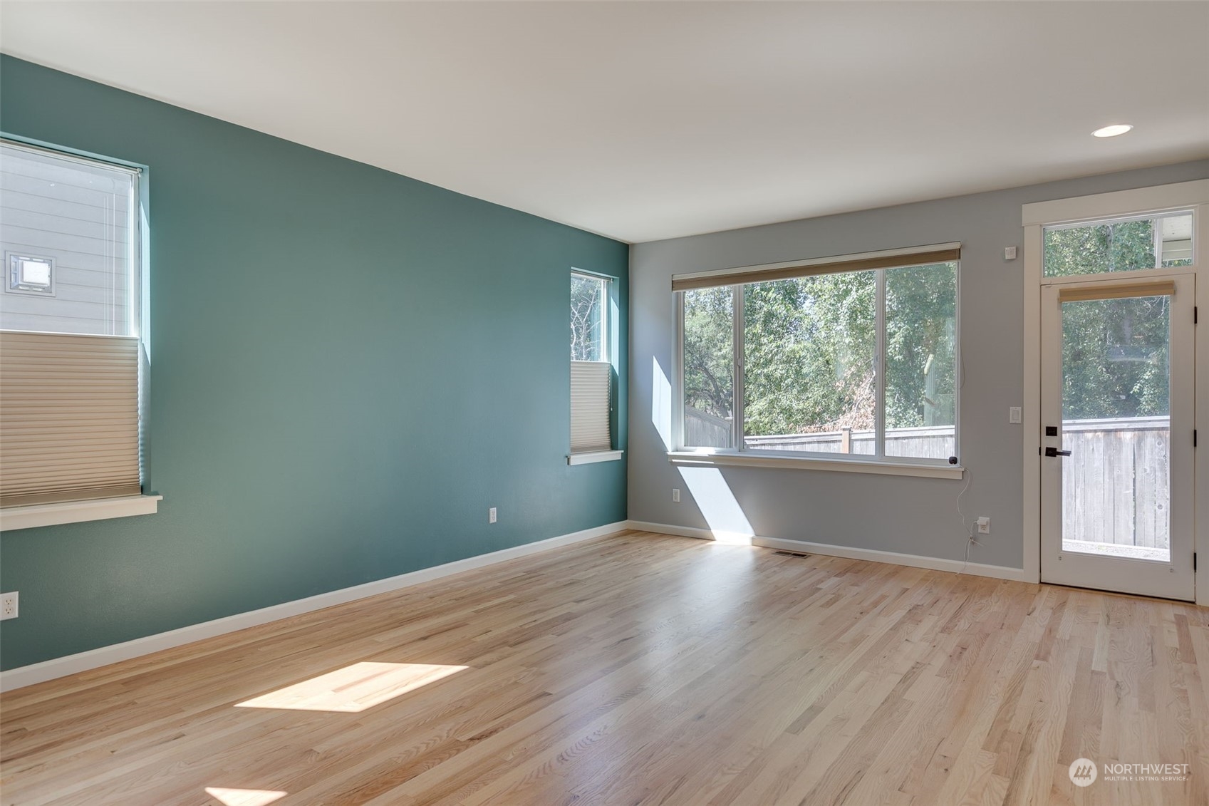 571 Lyons Place Northeast Renton, WA 98059 - Photo 9 of 27 a view of a big room with wooden floor and windows