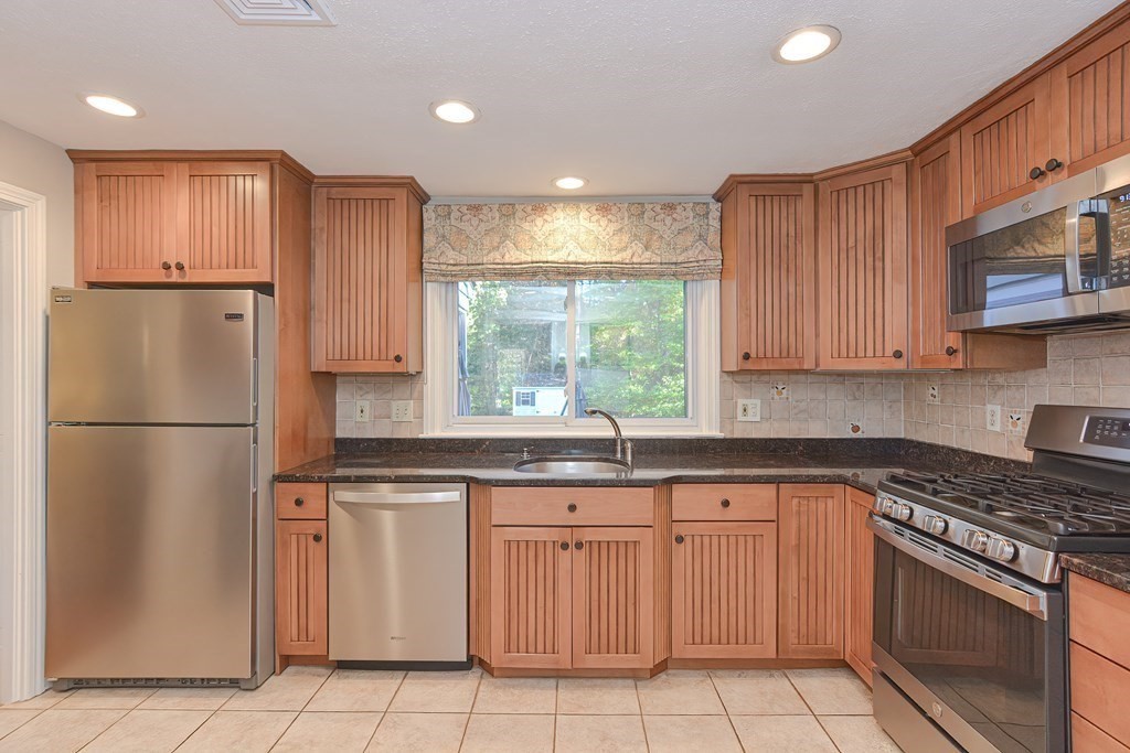7 Tamarack Road Medfield, MA 02052 - Photo 12 of 33 a kitchen with white cabinets stainless steel appliances and a sink