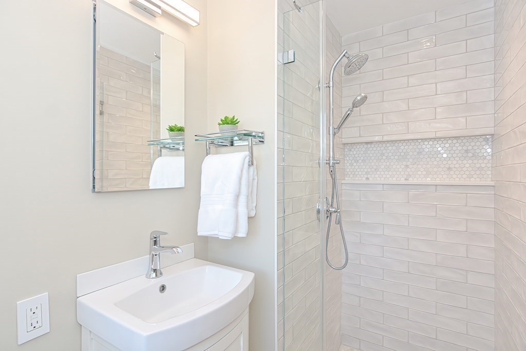 7 Tamarack Road Medfield, MA 02052 - Photo 15 of 33 a bathroom with a sink and mirror