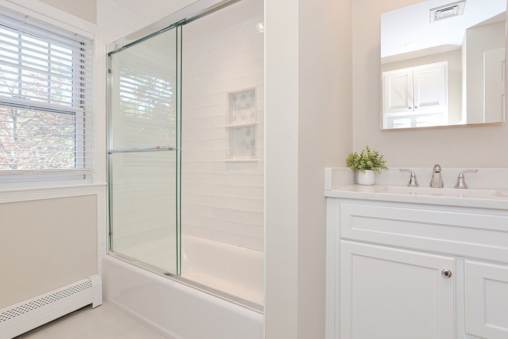 7 Tamarack Road Medfield, MA 02052 - Photo 20 of 33 a bathroom with a shower sink and a mirror
