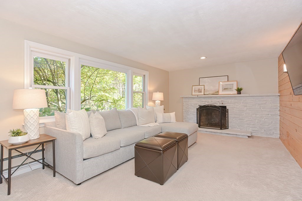 7 Tamarack Road Medfield, MA 02052 - Photo 21 of 33 a living room with furniture a large window and a fireplace