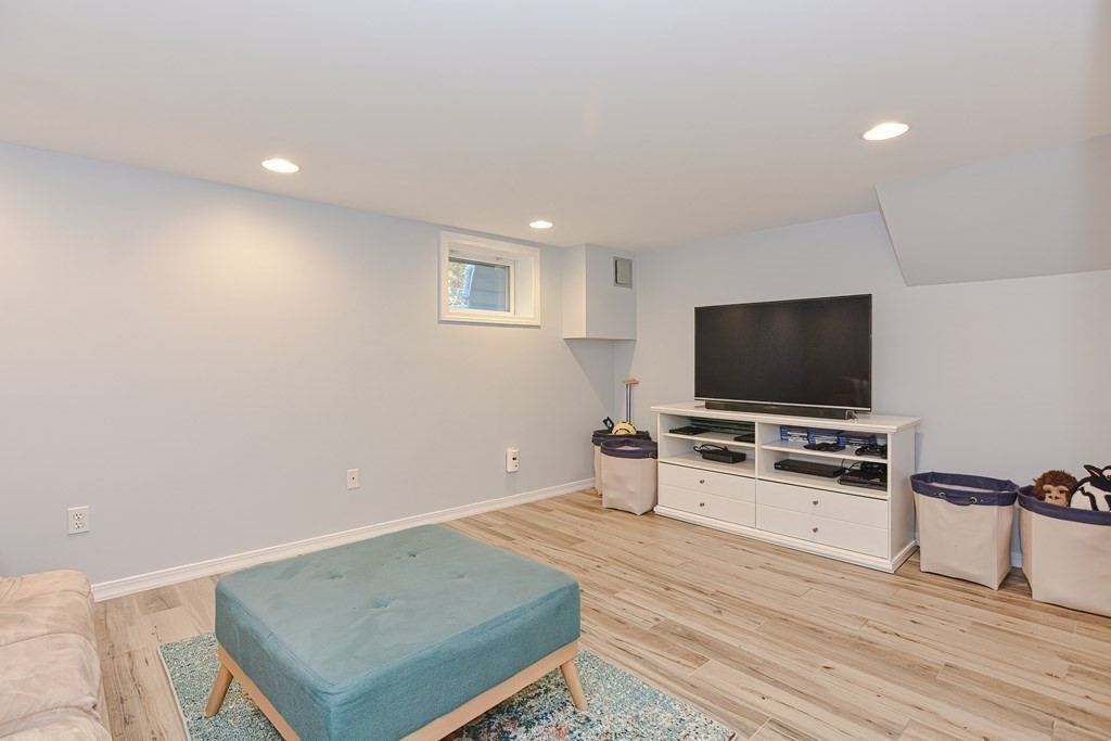 7 Tamarack Road Medfield, MA 02052 - Photo 26 of 33 a living room with furniture and a flat screen tv
