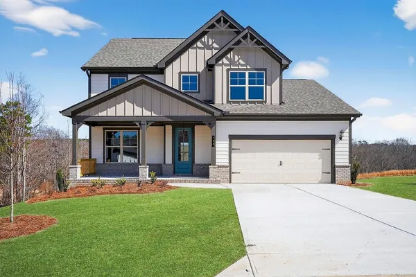 a front view of a house with a yard and garage