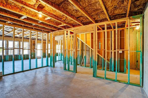 a view of an empty room with floor to ceiling window and stairs