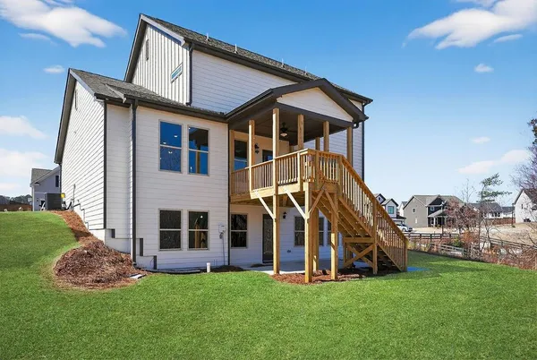 a view of a house with a yard and sitting area