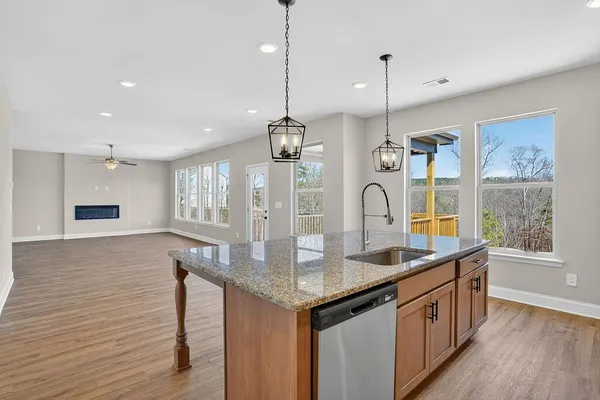a kitchen that has a lot of cabinets and wooden floor