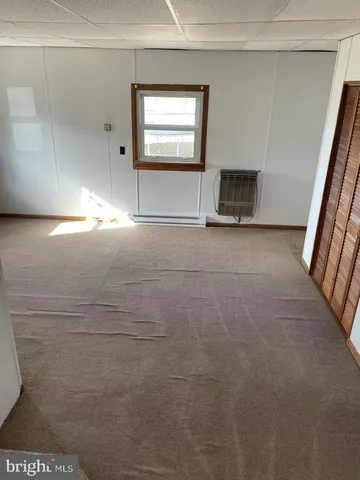 a view of an empty room with a fireplace