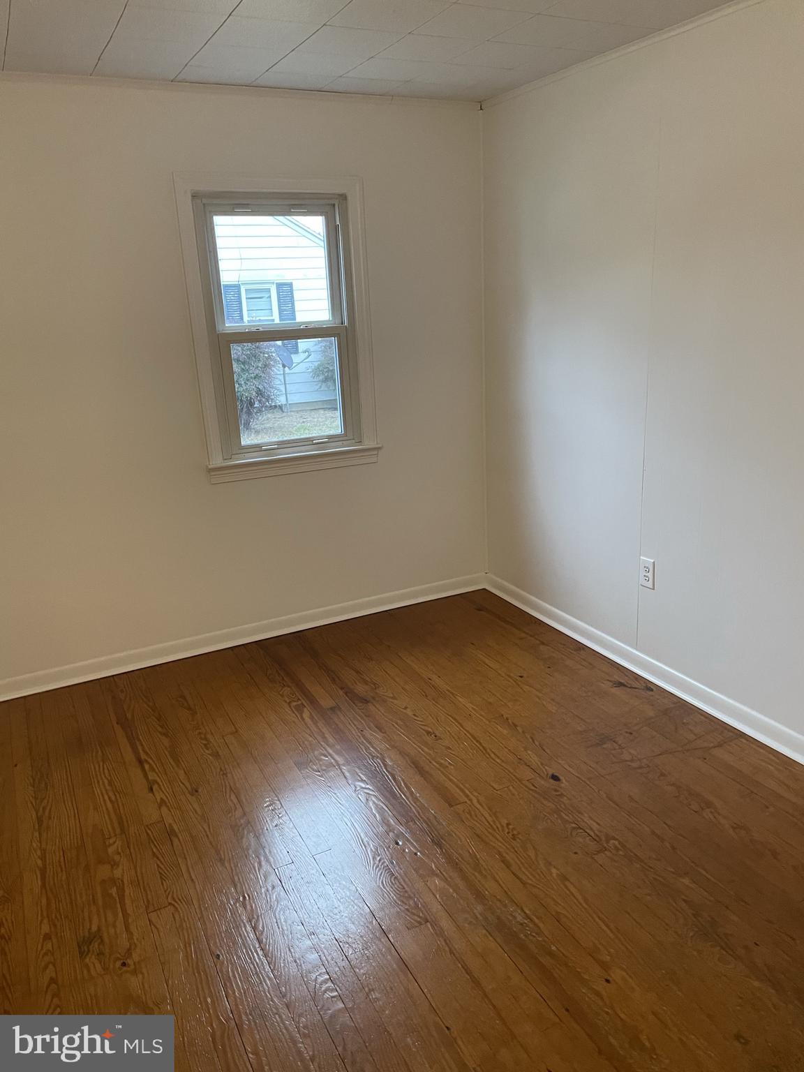 3530 Houston Branch Road Federalsburg, MD 21632 - Photo 13 of 20 an empty room with wooden floor and windows