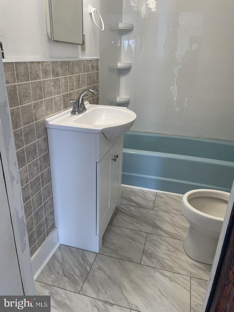 3530 Houston Branch Road Federalsburg, MD 21632 - Photo 14 of 20 a bathroom with a sink a toilet a mirror and bathtub