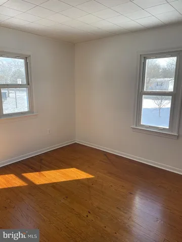 a utility room with wooden floor washer and dryer