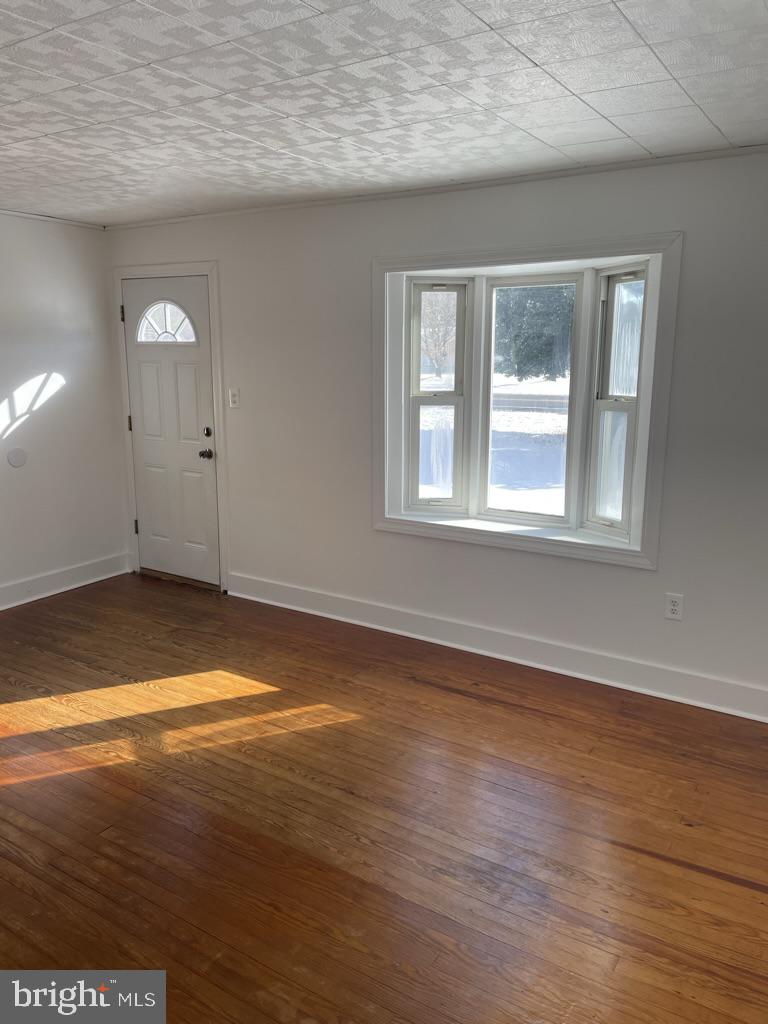 3530 Houston Branch Road Federalsburg, MD 21632 - Photo 2 of 20 an empty room with wooden floor and windows