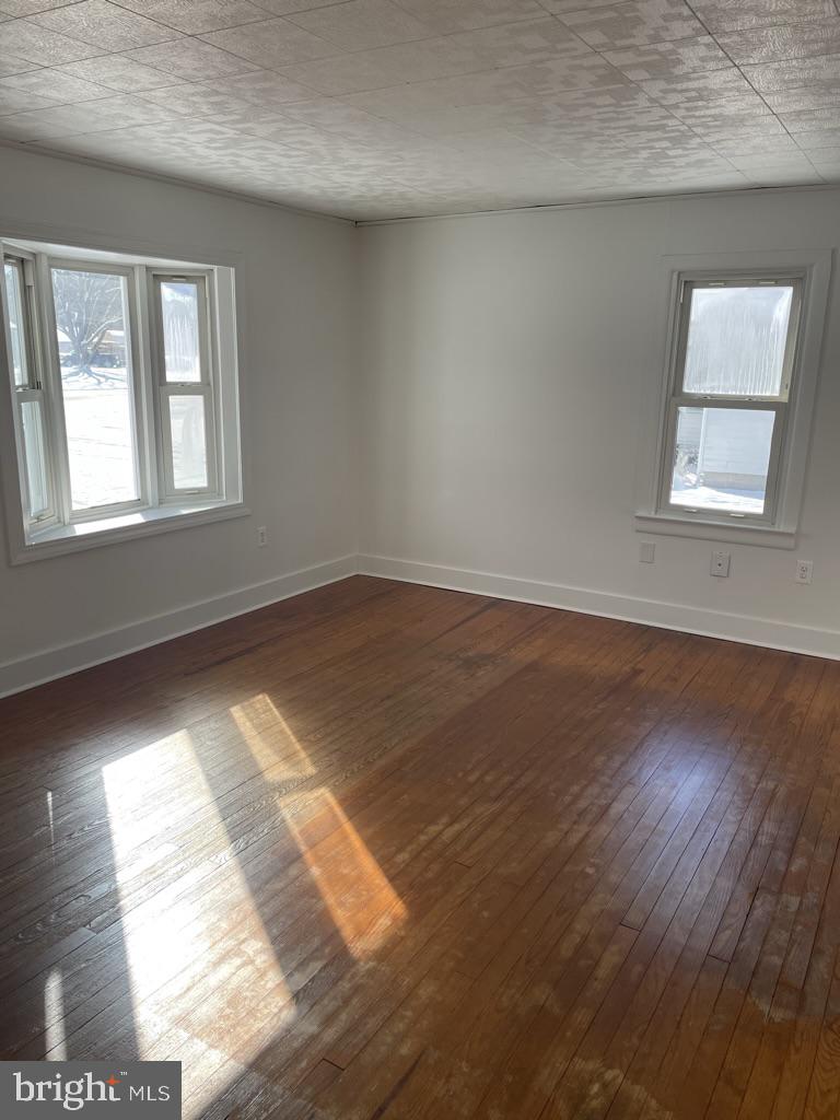 3530 Houston Branch Road Federalsburg, MD 21632 - Photo 4 of 20 an empty room with wooden floor and windows