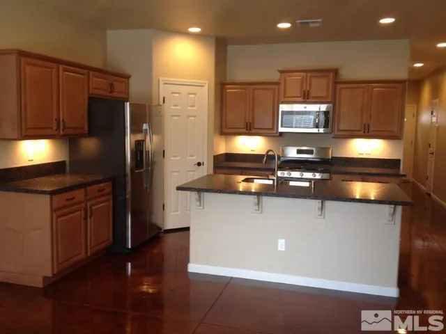 a kitchen with stainless steel appliances a refrigerator stove and oven