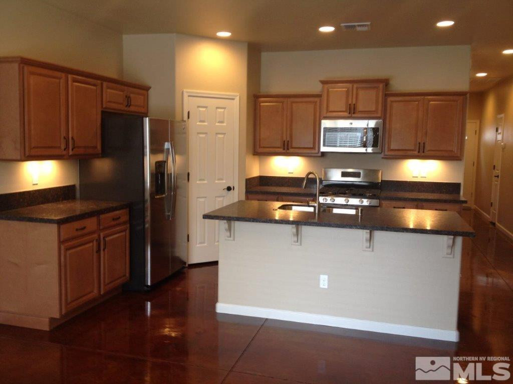 462 Laurel Street Reno, NV 89512 - Photo 2 of 16 a kitchen with stainless steel appliances a refrigerator stove and oven