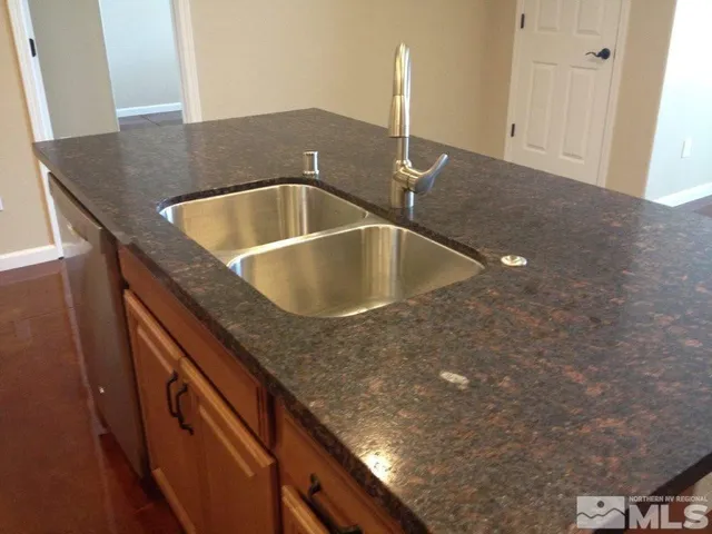 a kitchen with kitchen island a sink and a counter top