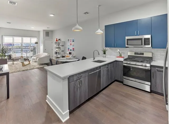 a kitchen with a sink stove and microwave