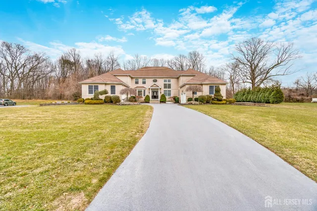 a view of an ocean with a house in the background