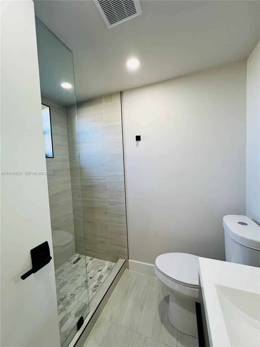3826 Southwest 107th Avenue, Unit 22 Miami, FL 33165 - Photo 5 of 18 a bathroom with a toilet and a shower
