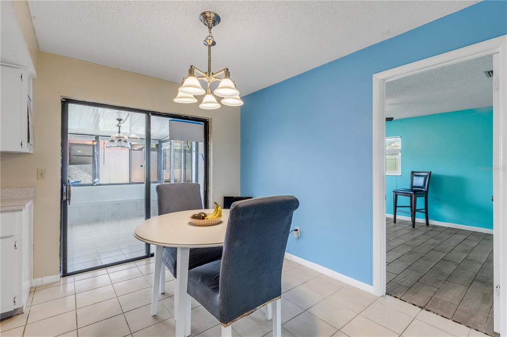 26 Laughing Gull Lane Edgewater, FL 32141 - Photo 11 of 66 a view of a dining room with furniture wooden floor and chandelier
