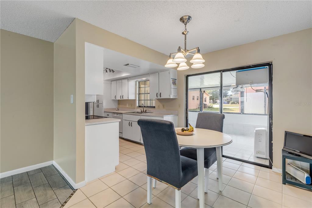 26 Laughing Gull Lane Edgewater, FL 32141 - Photo 12 of 66 a dining room with chandelier and glass door