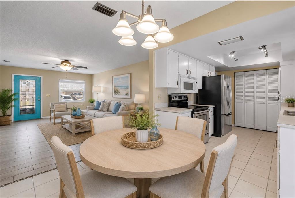 26 Laughing Gull Lane Edgewater, FL 32141 - Photo 13 of 66 a view of a dining room with furniture and chandelier