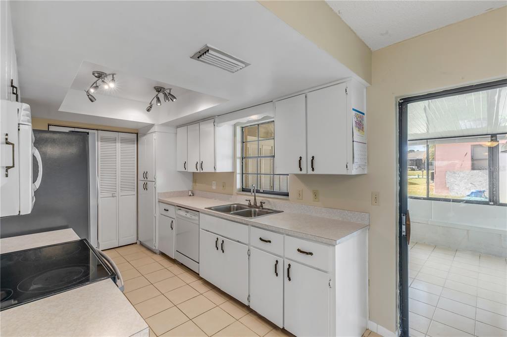 26 Laughing Gull Lane Edgewater, FL 32141 - Photo 15 of 66 a kitchen with a sink stove and cabinets