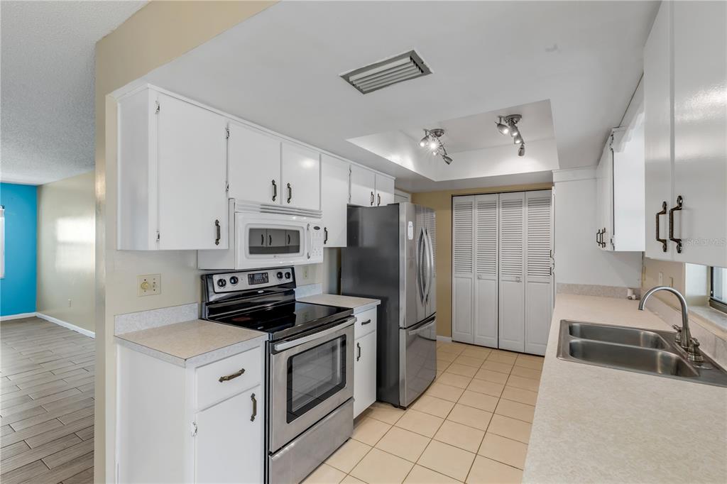 26 Laughing Gull Lane Edgewater, FL 32141 - Photo 16 of 66 a kitchen with stainless steel appliances a stove a sink and a refrigerator