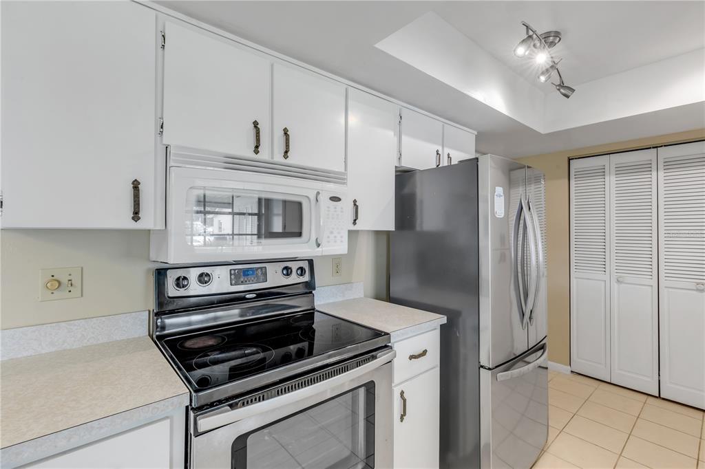 26 Laughing Gull Lane Edgewater, FL 32141 - Photo 18 of 66 a kitchen with stainless steel appliances a refrigerator and a stove top oven