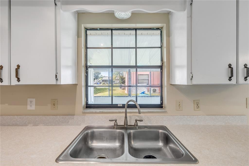 26 Laughing Gull Lane Edgewater, FL 32141 - Photo 19 of 66 a kitchen with a sink and cabinets