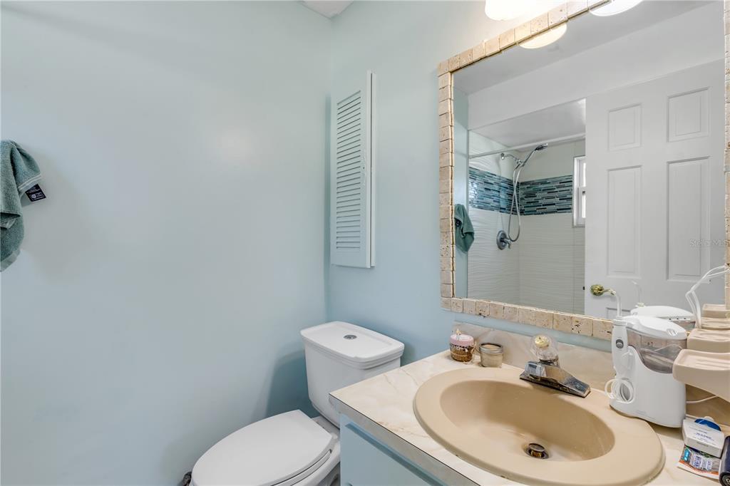 26 Laughing Gull Lane Edgewater, FL 32141 - Photo 25 of 66 a bathroom with a sink a toilet and mirror
