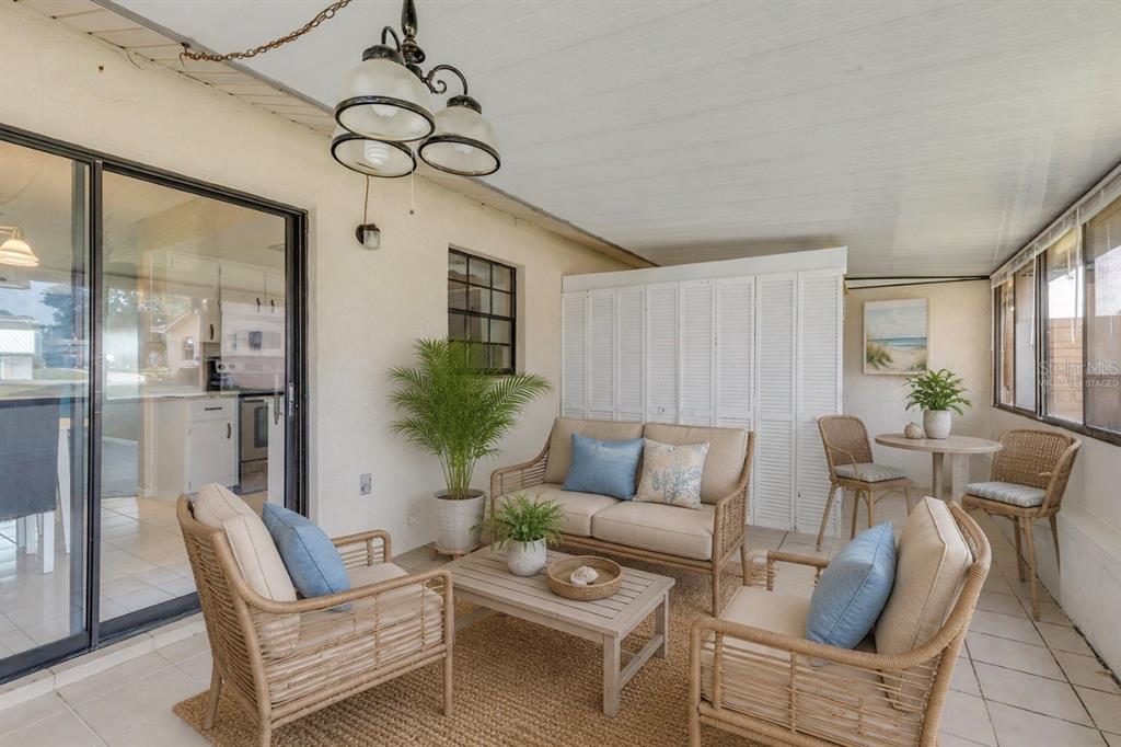 26 Laughing Gull Lane Edgewater, FL 32141 - Photo 31 of 66 a living room with furniture a chandelier and a dining table