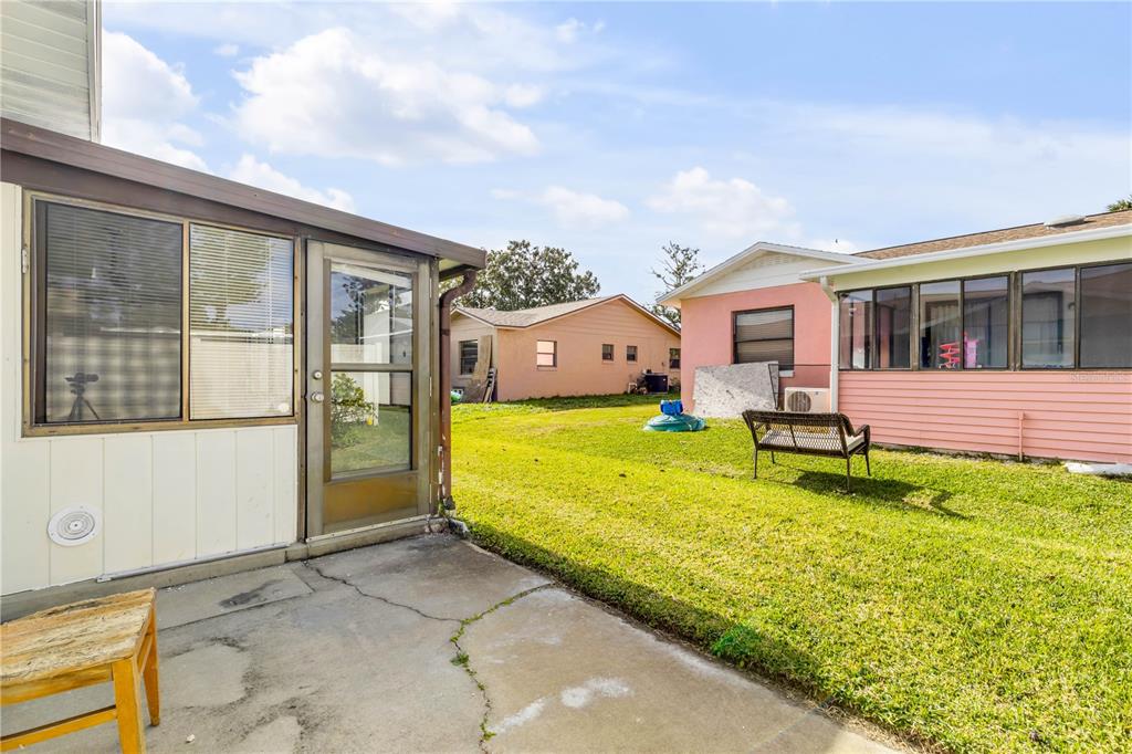 26 Laughing Gull Lane Edgewater, FL 32141 - Photo 36 of 66 a view of a house with a backyard porch and wooden floor